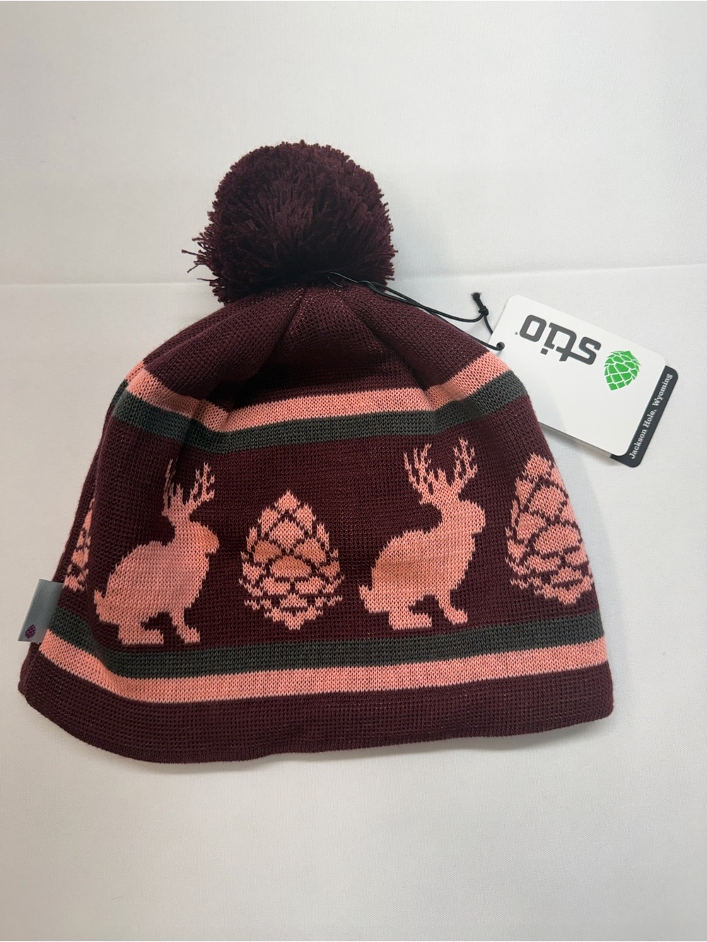 Stio Kids Pom Beanie in Burgundy and Pink with Hare & Pinecone Motif